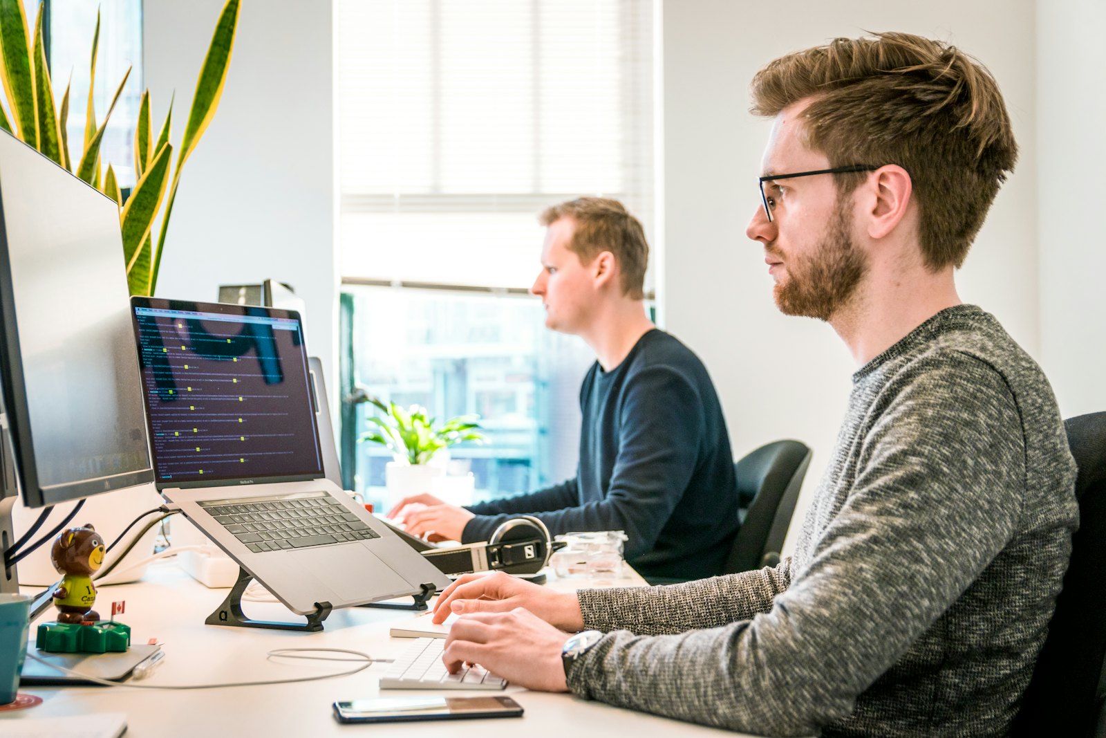 A diverse team of healthcare and technology professionals collaborating around data in a modern office