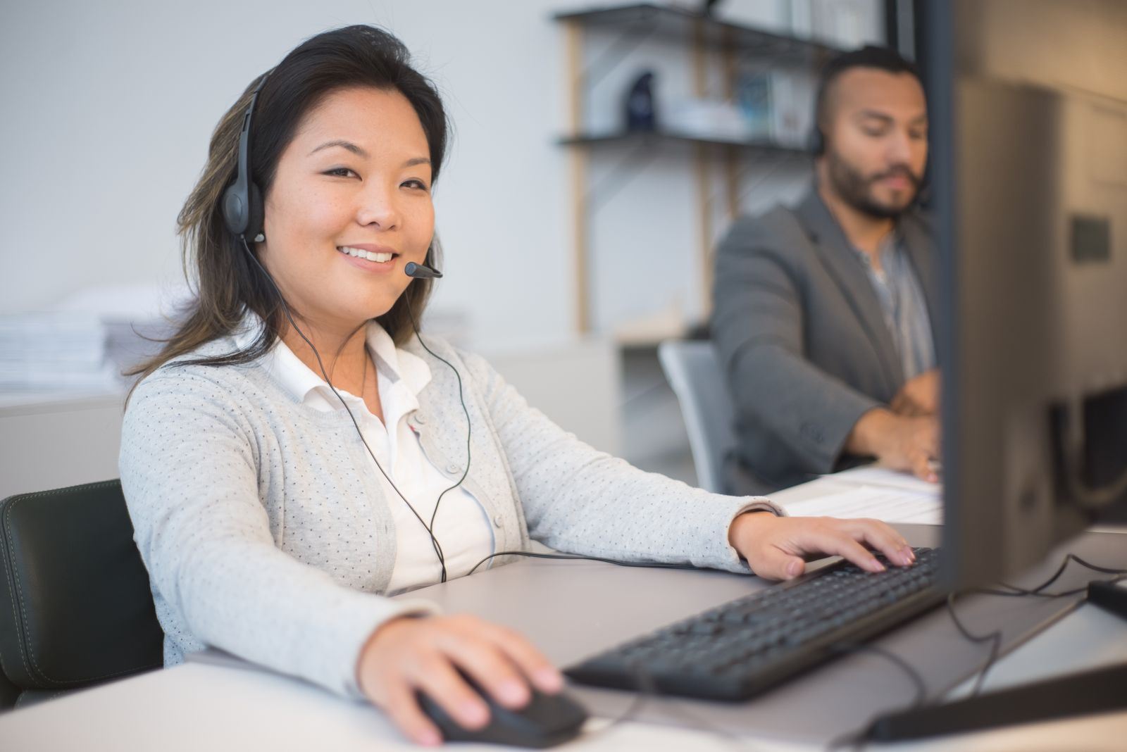 A friendly Consenta support professional ready to respond to enquiries in a modern office