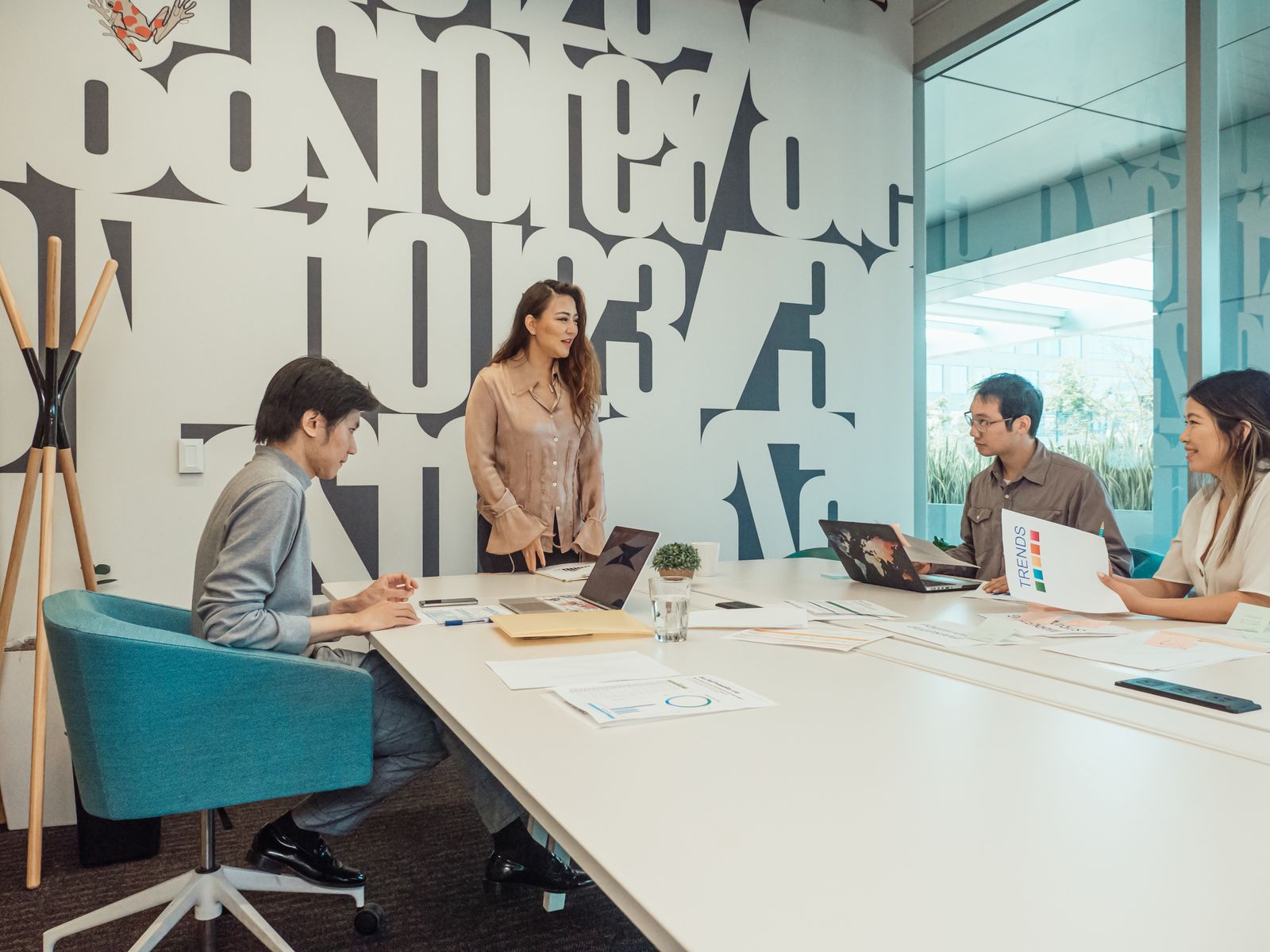 A diverse group of Consenta professionals collaborating in a bright modern meeting room
